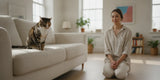 Cat sitting upright and coughing gently in a bright, calm home